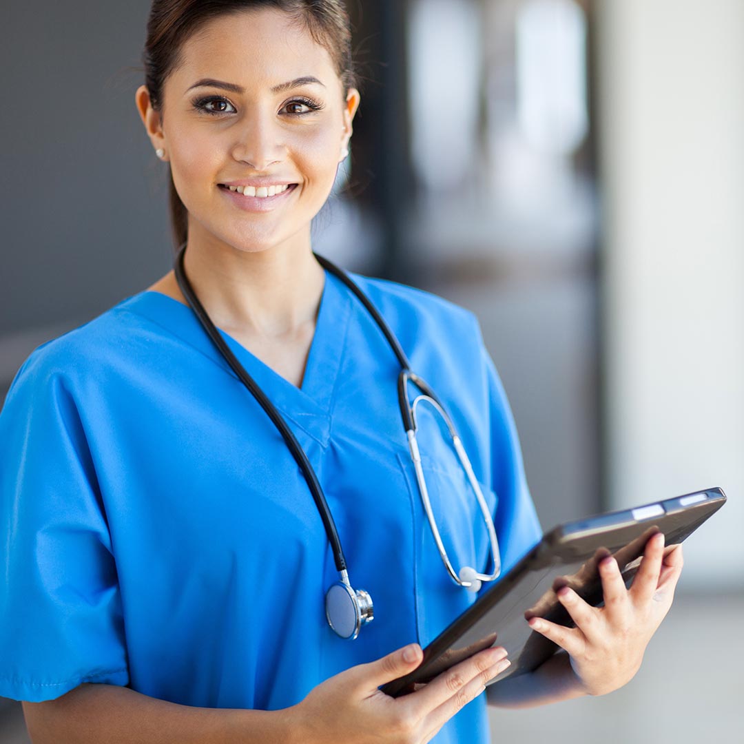 Smiling nurse holding a tablet